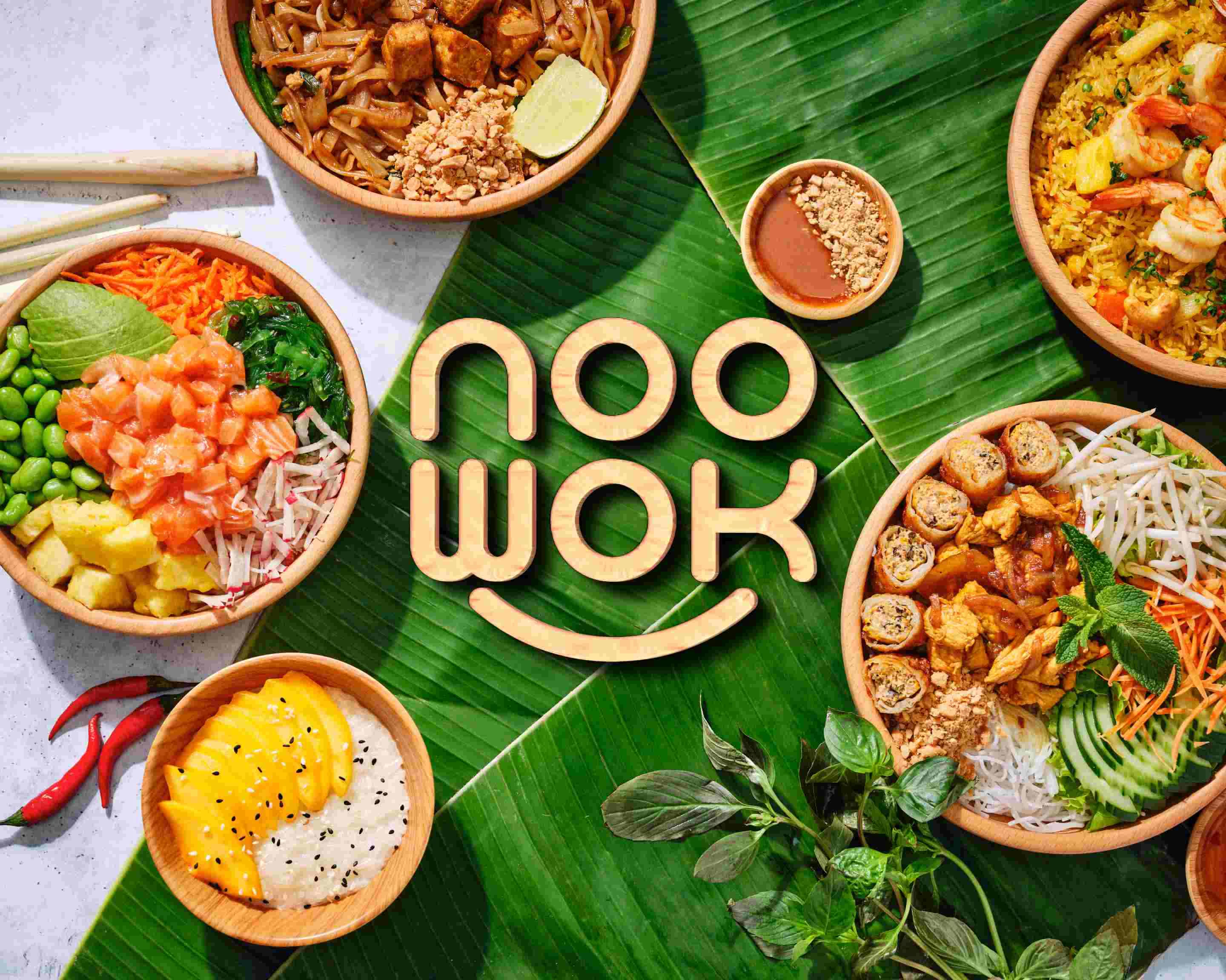 Les bols et spécialités de Noo Wok présentés sur des feuilles de bananier
